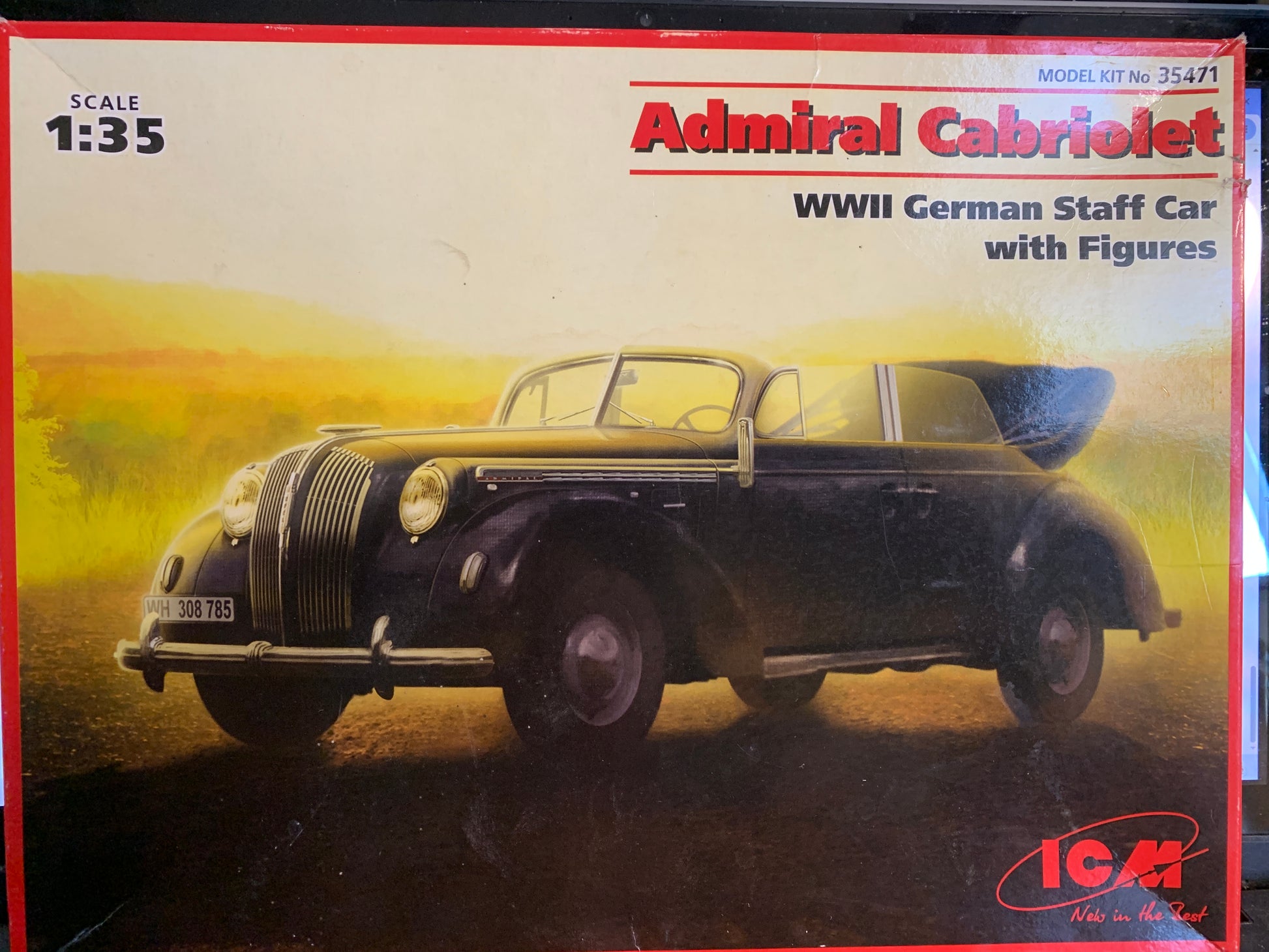 ICM 1:35 scale model kit box for the Admiral Cabriolet WWII German Staff Car with figures, featuring a vintage black car illustration on a warm yellow and orange background.